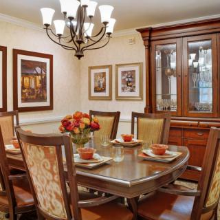 A classic dining room with wooden furniture and elegant decor.