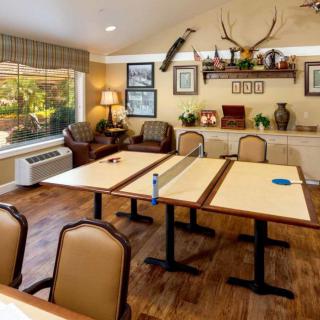 A well-decorated conference room featuring tables, chairs, and various wall decorations.