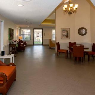 Spacious living area with comfortable seating and a chandelier.