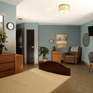 A cozy and modern bedroom showcasing minimalistic design with comfortable furnishings.