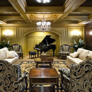 A luxurious living room featuring a grand piano and elegant furnishings.