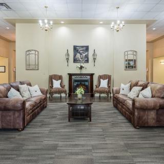 A cozy living room with matching leather sofas, a central coffee table, and elegant decor.