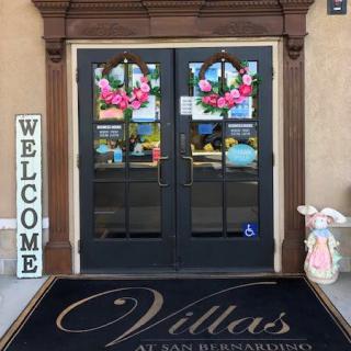 Entrance with decorative wreaths and welcome sign.