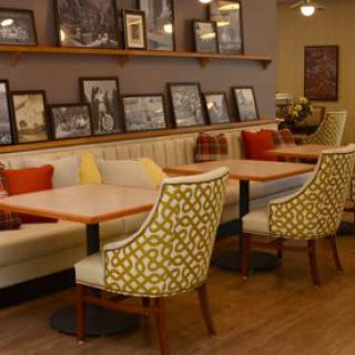 A cozy cafe interior with stylish seating and decorative elements.