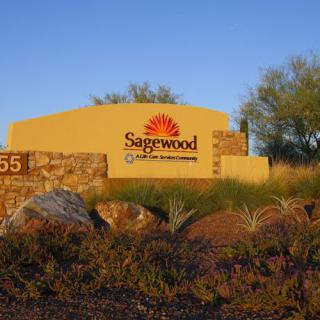 Entrance sign for Sagewood surrounded by desert landscaping.