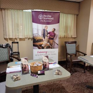 A display area featuring a banner and informational materials for home service offerings in a conference room setting.