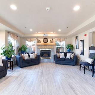 A spacious living room with elegant furniture and a cozy fireplace.