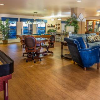 A modern living space featuring a blend of comfortable seating, a dining area, and stylish decor.
