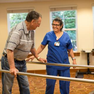A physical therapist assists a patient during rehabilitation exercises.