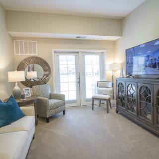 A cozy living room with comfortable seating, stylish decor, and a television for entertainment.