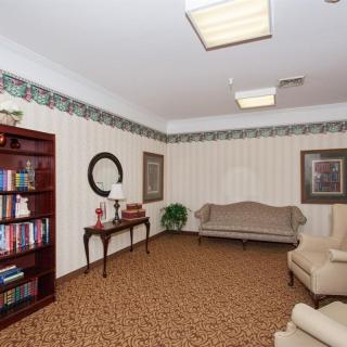 A cozy living room with a bookshelf, sofa, and comfortable seating.