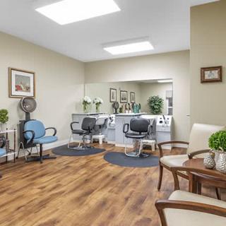 A cozy hair salon with styling chairs, mirrors, and a waiting area.
