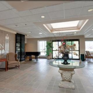 Spacious lobby with elegant decor and a grand piano.