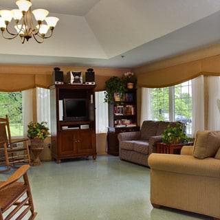 A cozy living room with comfortable seating and large windows providing natural light.