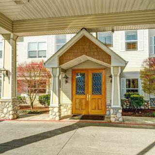 Entrance of a residential building with a covered driveway.