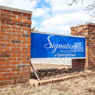Sign for Signature Health Care of Georgetown, displayed prominently on a brick structure.