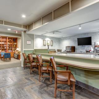 A cozy lounge area with a bar counter and comfortable seating.
