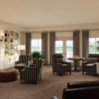 A spacious and elegantly designed living room with comfortable seating and large windows.