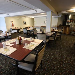 An indoor dining area with neatly arranged tables and chairs.