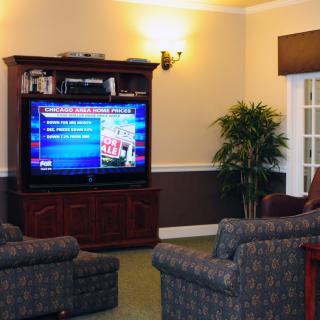 A cozy living room with comfortable seating and a large television.