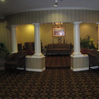 A cozy hotel lobby featuring elegant columns and comfortable seating.