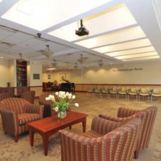 A modern waiting room with comfortable seating and ambient lighting.