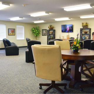 A spacious office meeting area with seating and a television.