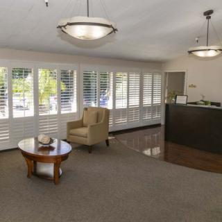 A modern office lobby with seating and a reception desk.
