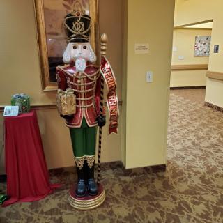 A festive nutcracker decoration stands in a welcoming lobby, adding holiday cheer.