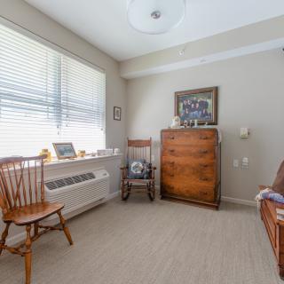 A cozy room with wooden furniture and ample natural light.