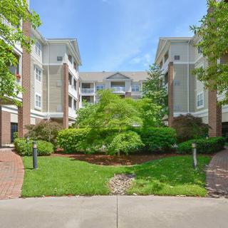 A residential apartment complex with well-maintained landscaping and greenery.