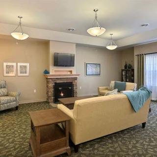 A cozy living room with a sofa, a coffee table, and a fireplace.