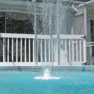 A backyard swimming pool featuring a bubbling fountain in the center.