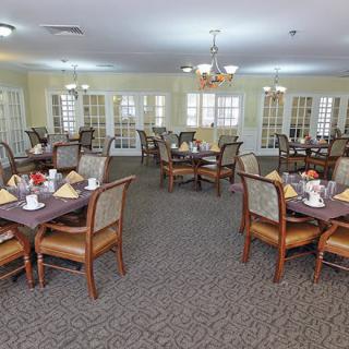A spacious dining room with neatly arranged tables and chairs, ready for guests.