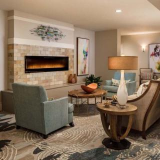 A modern living room with stylish furniture and a cozy fireplace.