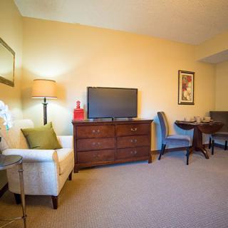 A cozy living room setup with a TV, comfortable seating, and elegant decor.