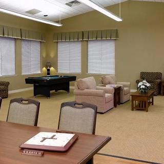 A spacious lounge area with seating and a pool table.