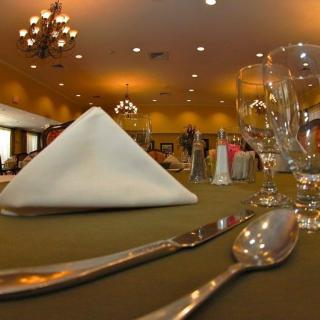 Elegant restaurant table setting with folded napkin and silverware.