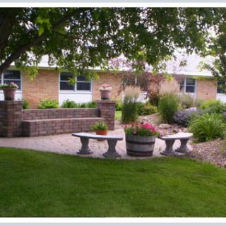 A tranquil garden with benches and lush greenery.