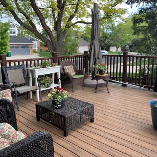 A cozy patio with comfortable seating and potted plants.