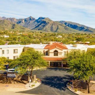 A hotel nestled in a picturesque desert landscape with mountains in the background.