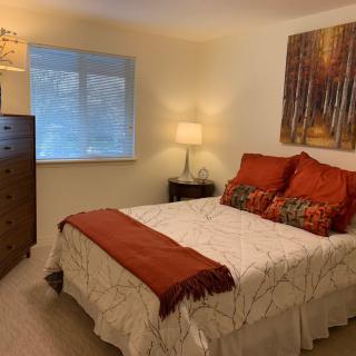 A cozy bedroom with warm-toned decor and soft lighting.