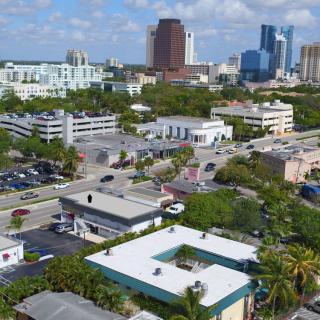 Aerial view of a cityscape with buildings and a clear blue sky.