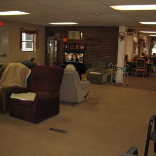 A cozy living room with sofas and a television.