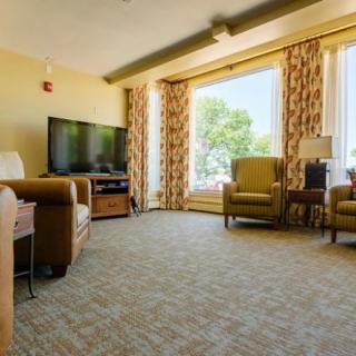 A cozy living room with comfortable seating and a large window.