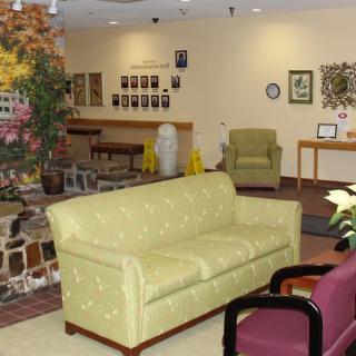 A cozy waiting room with comfortable seating and decor.