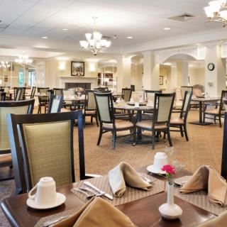 An elegant restaurant dining room with neatly arranged tables and chairs, ready to welcome guests.