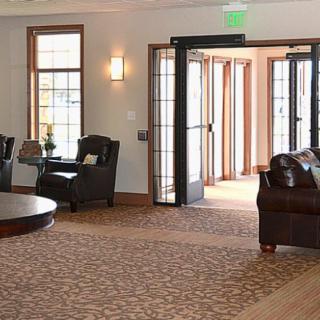 A spacious lobby area with comfortable seating and large windows.