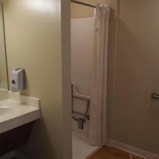 Accessible bathroom with shower and handrails