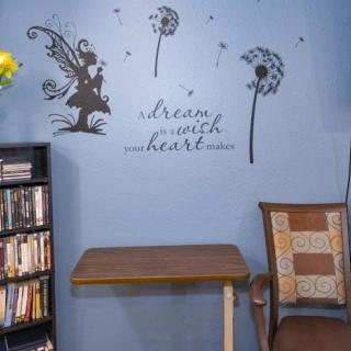 A cozy reading corner with wall art and inspirational quotes.